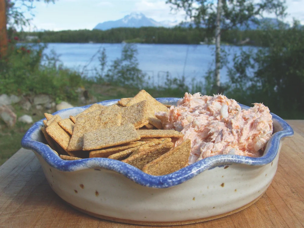 Smoked salmon dip served alongside crackers.